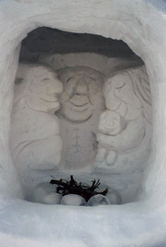 A carving depicting a happy little family inside a snow house sitting by a fire. We used frozen water-filled balloons to create the fire rocks! (Photo by Jodine Pratt/NCC staff)