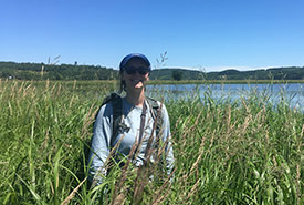Allison Patrick stands among the tall grasses and wildflowers at NCC's property on Hog Island. (Photo by NCC)