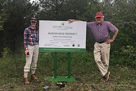 Richard with former NCC staff Ali Giroux installing a property sign at an NCC nature reserve in the county (Photo by Amanda Tracey/NCC staff)