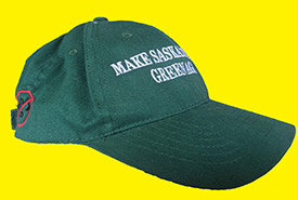 A green ball cap with words that say 
