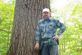 Dan Kraus with a big, old-growth white pine in Algonquin Park, ON (Photo courtesy of Dan Kraus/ NCC staff)