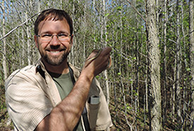 Wildlife photographer and naturalist Bill Hubick holds up an eastern ribbon snake (Photo courtesy of Bill Hubick)
