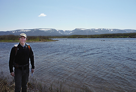 Brandon Ward posing for a picture while performing forest ecological classification (FEC) on the Grand Codroy Estuary (Photo by NCCl)