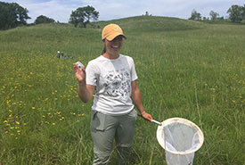 Field technician Breanne Kenner with a successful catch! (Photo by NCC)