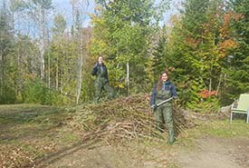 CCC participants cutting invasive phragmites stems (Photo by NCC)