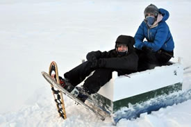 Lindsay Notzl and Jon Feldgajer in a komatik, Labrador (Photo by Larry Innes)