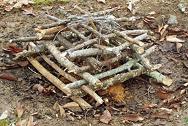 Starting a fire using log-house-style branches (Phot by Scouts Canada)