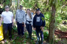 The crew of technicians from the Wuikinuxv Coastal Guardian Watchmen and the Raincoast Conservation Foundation finishing up at a non-invasive bear hair sampling station in Wuikinuxv territory, BC (Photo courtesy of Megan Adams)