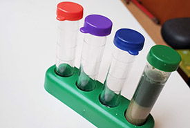 A soil test kit with one tube filled, showing one test in use and it indicates alkaline pH (Photo by Wendy Ho/NCC staff)