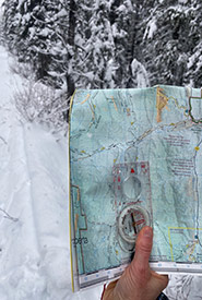 A topographic map and a compass (Photo by Gayle Roodman/NCC staff)
