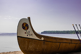 The canoe on the beach, with Batchewana Island in the background. (Photo by Andrea J Moreau/NCC staff)