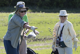 Volunteer throwing seed bombs into experimental test plot at Conservation Volunteers event in Alberta. (Photo by NCC)