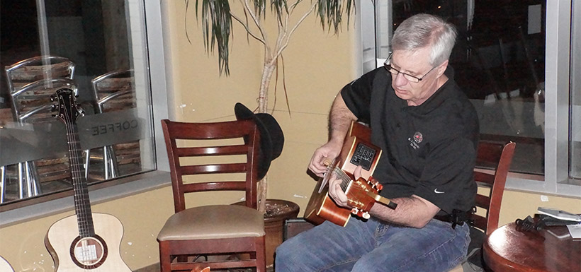 Blair Turner playing guitar at the Creekside Good Earth Coffeehouse (Photo by NCC)