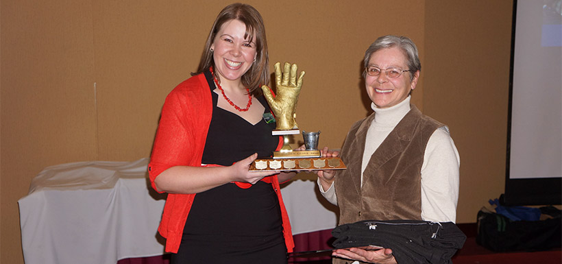 NCC volunteer Denise Harris is on the right accepting her Golden Glove award. (Photo by NCC)