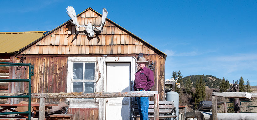 Val Dennis and the historic cabin on Dennis Ranch (photo by NCC)