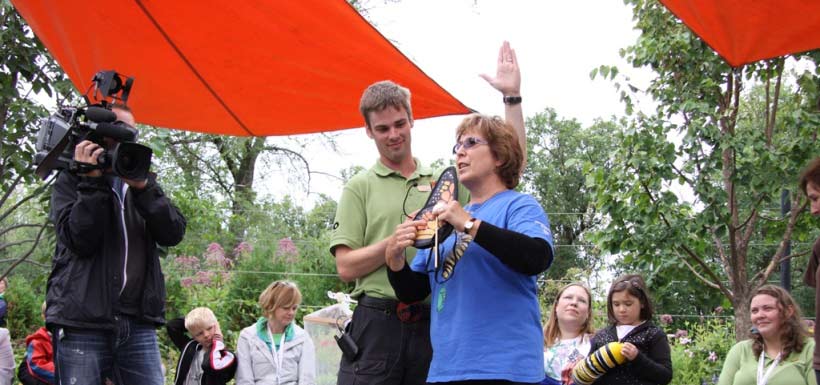 Monarch Teacher Network teaches crowd how to tag a butterfly, MB (Photo by NCC)