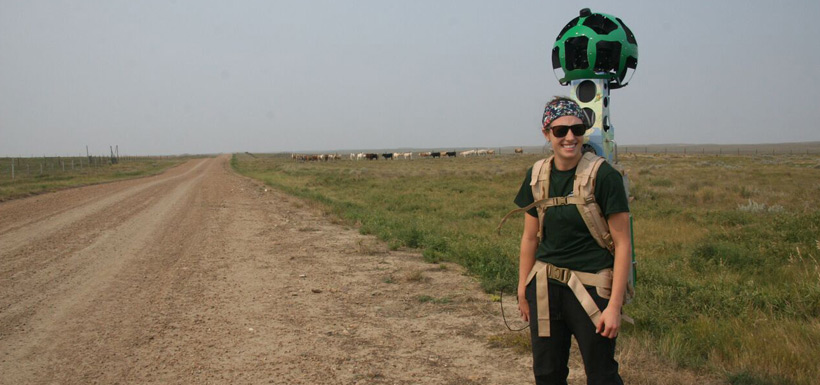 Carissa Sideroff, natural areas assistant for Southwestern Saskatchewan, with grazing bison on Old Man on his Back Nature Reserve (Photo by NCC)