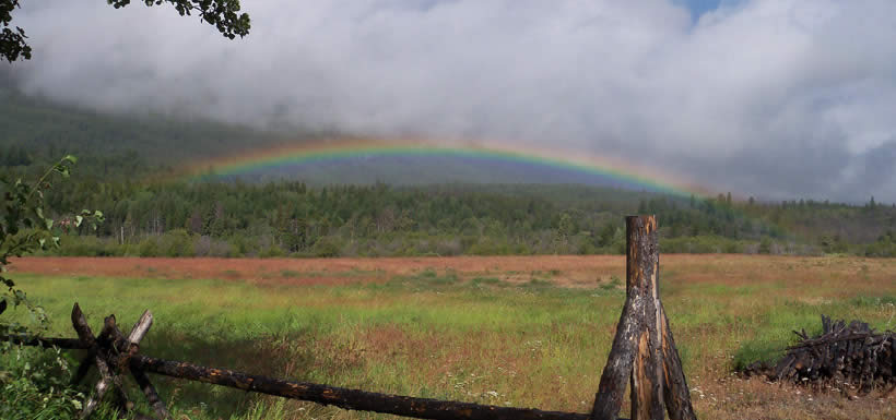 A rainbow shines over the fields of NCC�s Tatlayoko Lake Ranch (Photo by Chris Chutter)