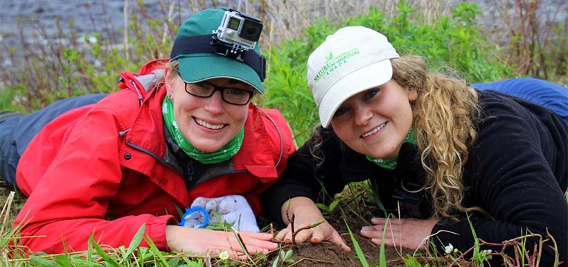 Megan Lafferty and a volunteer planting a tree along Crabbes River (Photo by A. Mahoney)