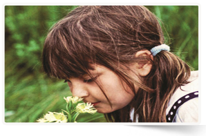 Chantal Fortney on the tall grass prairie with a western prairie fringed orchid (Photo by Gene Fortney)