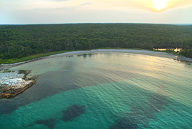 Aerial view of Port Joli, NS, showing its white sandy beach and aquamarine waters (Photo by Mike Dembeck)