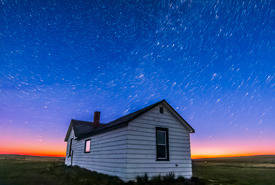 Star trails over Butala Homestead in OMB at dawn, SK (Photo by Alan Dyer)