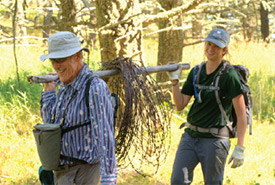 Conservation Volunteers transporting barbed wire (Photo by David Thomas)