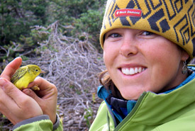 Jasmin Dobson holds a warbler at the Tatlayoko Lake Bird Observatory (Photo by NCC)