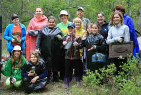 A Conservation Volunteers event in 2015 attended by Virden Girl Guides. They got their hands dirty cleaning up old shingles and debris from the Jiggens Bluff property in Manitoba. (Photo by NCC)