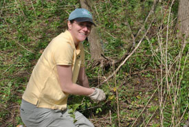 Lisa McLaughlin removing invasive garlic mustard from Happy Valley Forest, ON (Photo by NCC)
