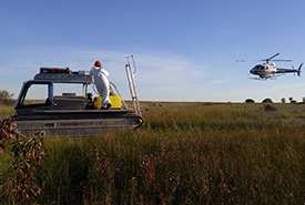 Marsh master and helicopter, Long Point, ON (Photo by Giles Restoration Services Inc.)